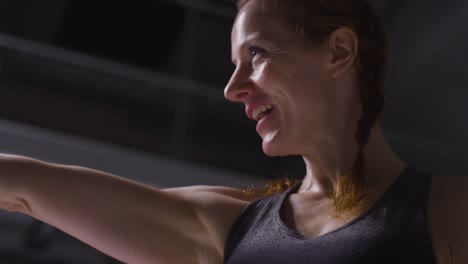 Portrait-Shot-Of-Mature-Smiling-Woman-Wearing-Gym-Fitness-Clothing-Exercising